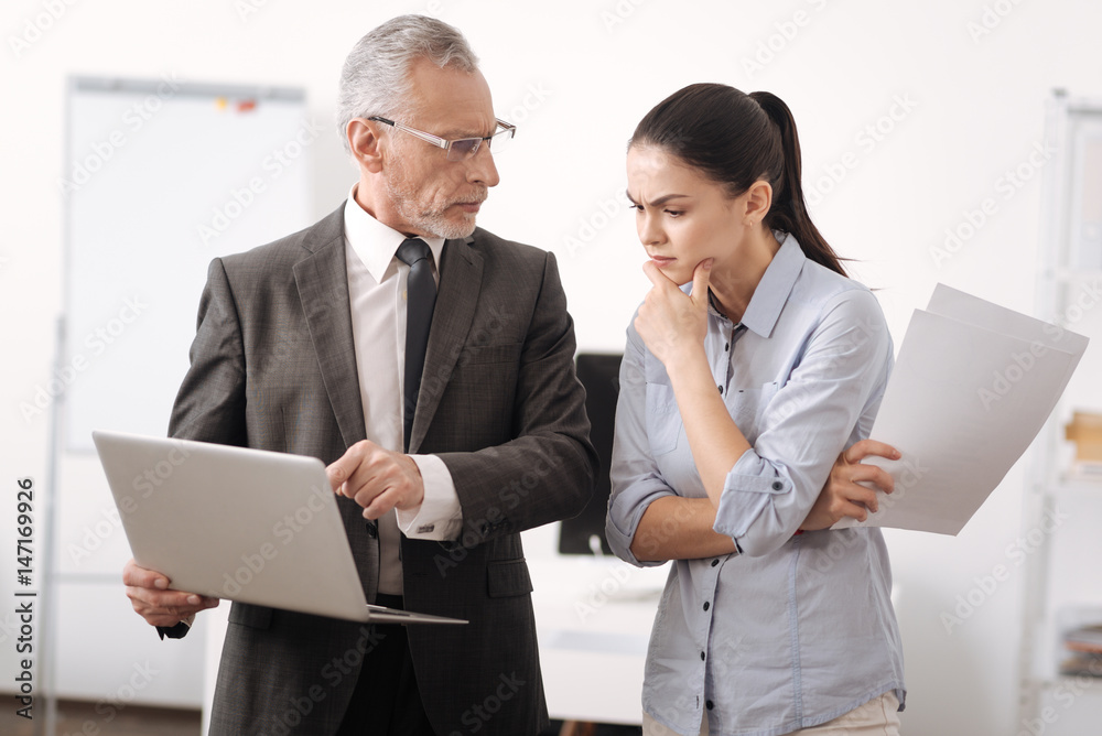 Fototapeta premium Angry boss using laptop while working