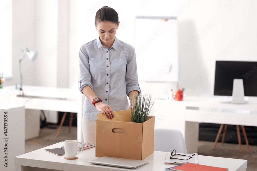 Upset female putting folder into box Upset female putting folder into box