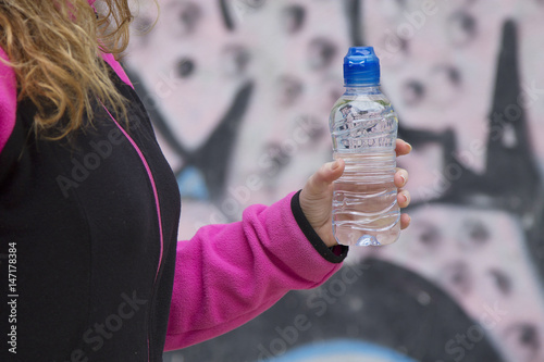Woman athlete with water bottle