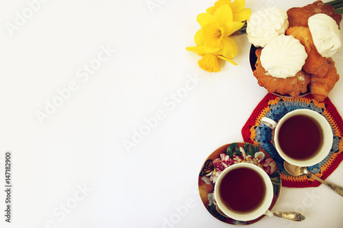 Black tea and biscuits on a light background