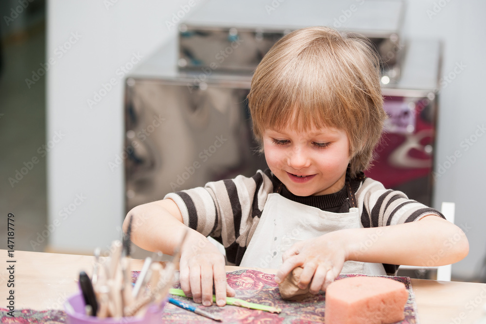 small boys make a product made of ceramics small boys make a product made of ceramics