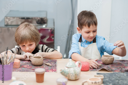 Little girl makes a ceramic product