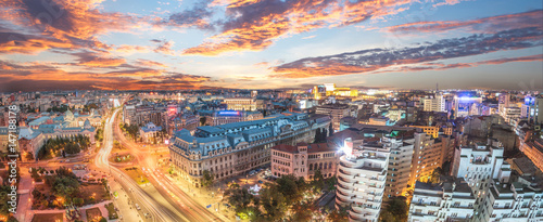 Panorama of traffic lights in the center of the capital city of Romania. Center of Bucharest at sunset. Romanian Parliament and University square.