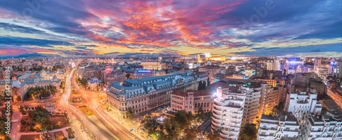 Panorama of traffic lights in the center of the capital city of Romania. Center of Bucharest at sunset. Romanian Parliament and University square.