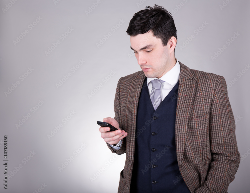 business man using smart phone over grey business man using smart phone over grey