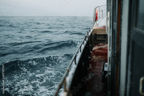 Fishing ship is swimming at sea at winter © Ivan Kurmyshov