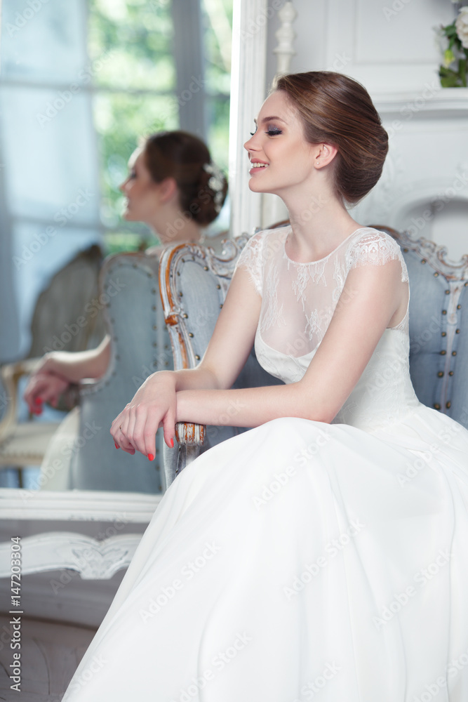 A young beautiful bride in a chic interior.