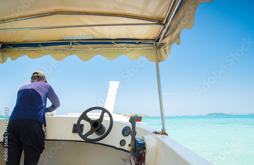 Steering wheel motor boats moored with blue sky sand sun daylight,Thailand.