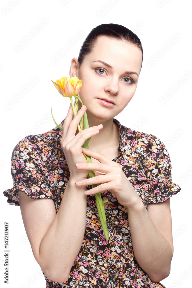 Attractive young woman holding a yellow tulip Attractive young woman holding a yellow tulip