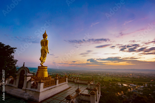 Wat Phra That Khao Noi, Nan Province, Thailand, Golden Buddha statue standing on a mountain,City of cultural and natural tourism in the north,selective focus © Have a nice day 