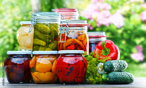 Jars of pickled vegetables and fruits in the garden