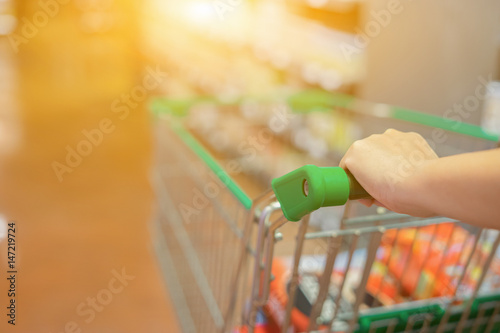 Abstract blurred photo of trolley in department store bokeh background,Shopping cart in supermarket ,vintage color