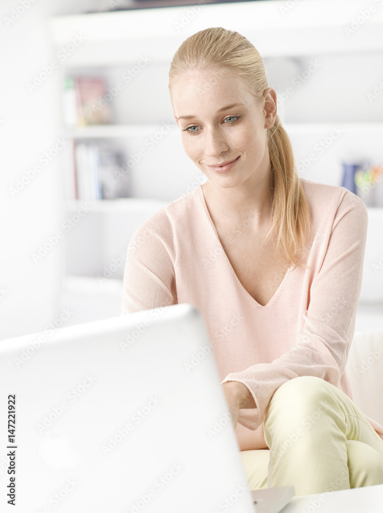 Home office. Shot of a beautiful young woman using her laptop at home. Home office. Shot of a beautiful young woman using her laptop at home.