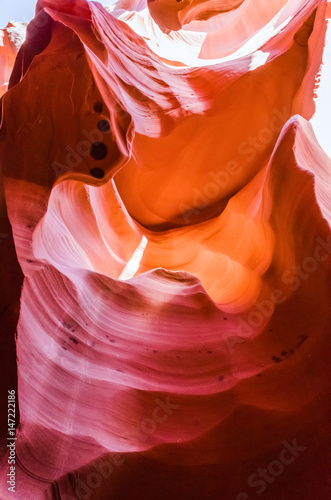 Dark orange wave shapes photographed at slots canyons sunset in Arizona.