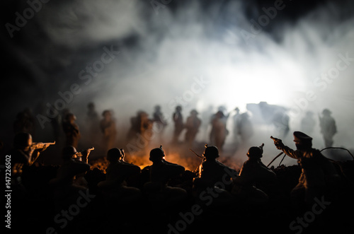 War Concept. Military silhouettes fighting scene on war fog sky background, World War Soldiers Silhouettes Below Cloudy Skyline At night. Attack scene. Armored vehicles © zef art