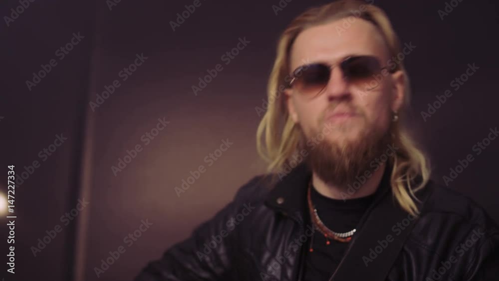 Hands and Face of a Bearded Man Playing Guitar