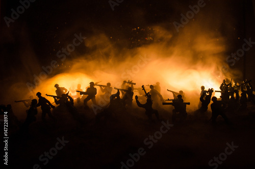 War Concept. Military silhouettes fighting scene on war fog sky background, World War Soldiers Silhouettes Below Cloudy Skyline At night. Attack scene. Armored vehicles. © zef art