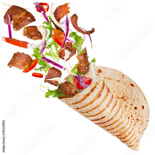 Kebab sandwich with flying ingredients.