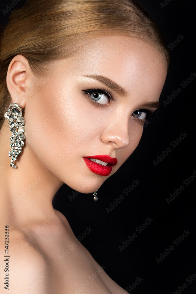 Fototapeta premium Portrait of young beautiful woman with evening make up