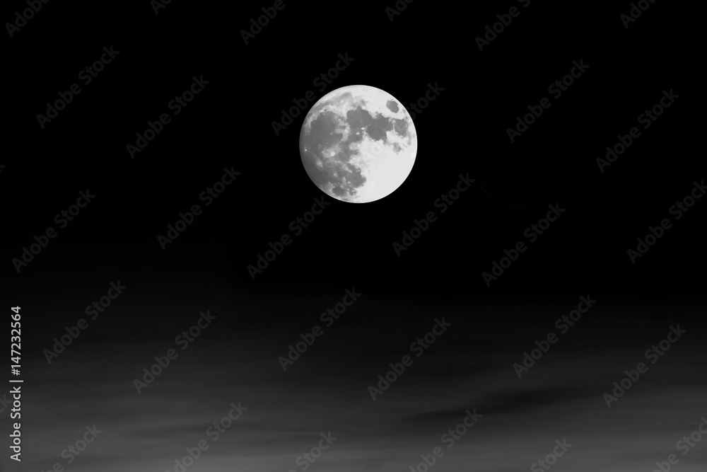 Fototapeta premium Full moon on black. Astronomy shot of the planets and the starry sky. The scene with the round moon. The mystical nature time.
