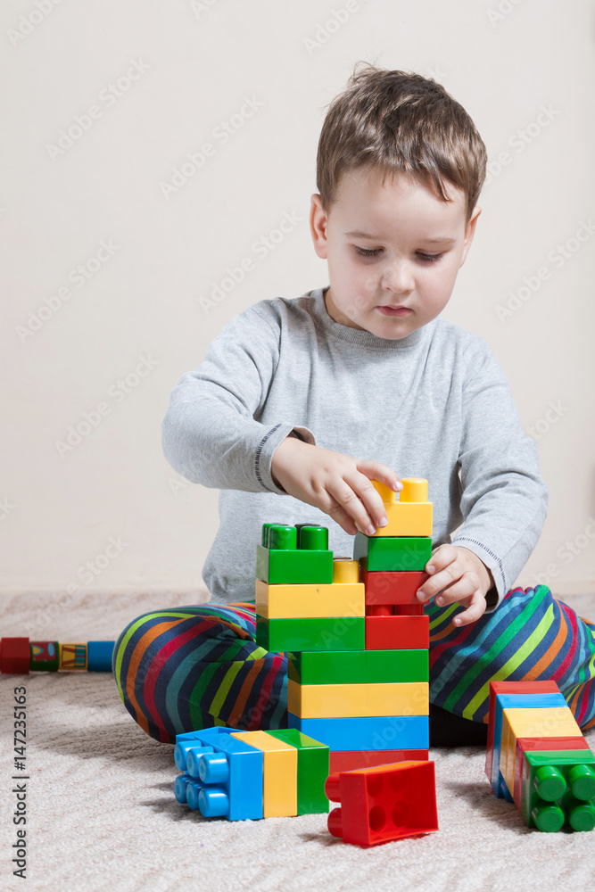 Playing little boy with colored cubes Playing little boy with colored cubes