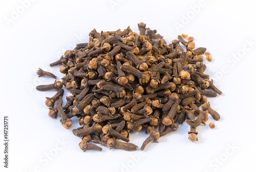 Cloves (Eugenia caryophyllata), pile on white beckground photo