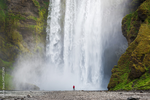 Tourist near Skogafoss waterfall in Iceland