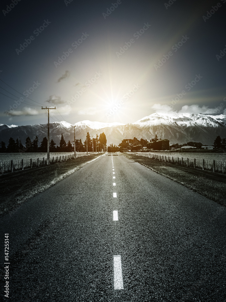 road to the alps with dramatic sun light