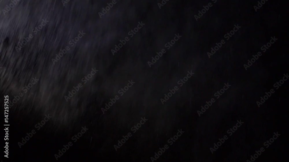 Some dust of liquid particles flowing on dark background