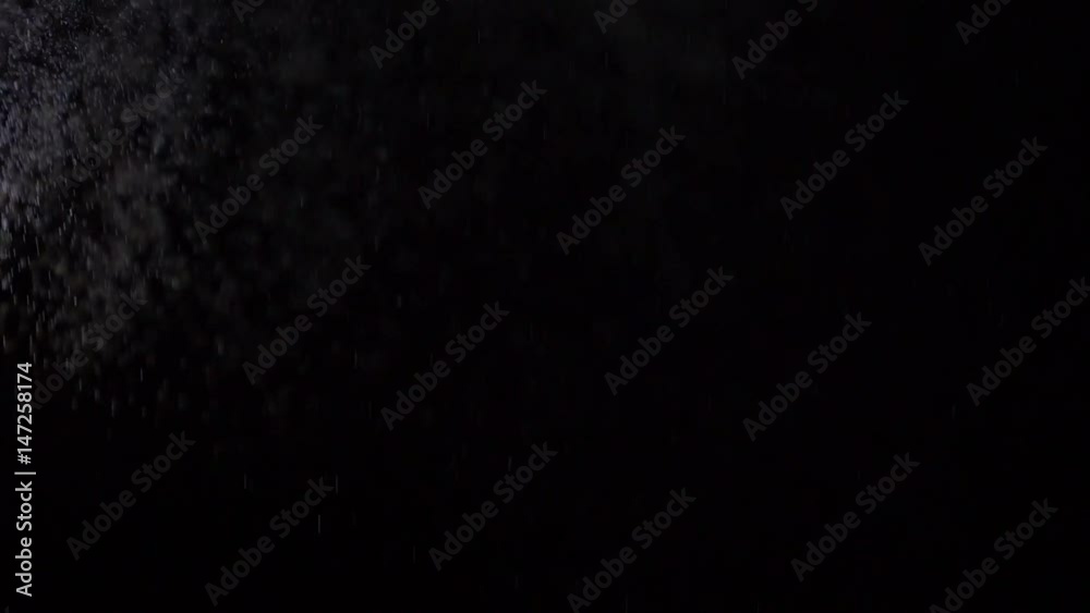 Some dust of liquid particles flowing on dark background