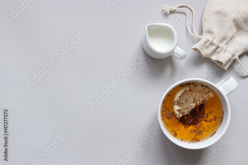 Tea background. Cup of hot black tea on the blue background, top view. Copy space