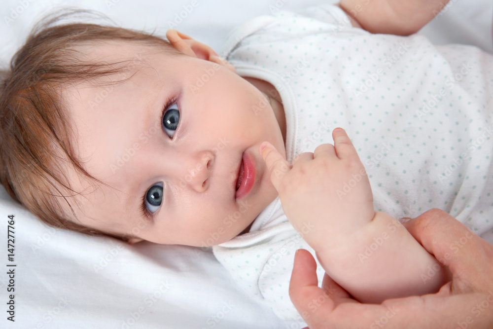 Mother holding baby hand, closeup Mother holding baby hand, closeup