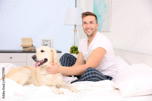 Handsome man playing with d...