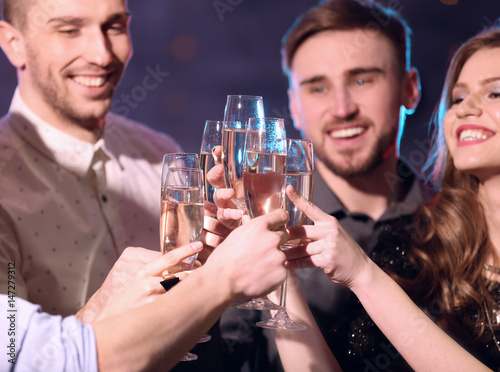 Friends clinking glasses of...