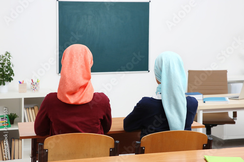 Two girls sitting at desk i...