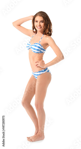 Beautiful young woman in swimsuit on white background