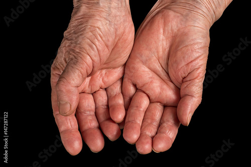 Senior woman  wrinkled hands. Isolated on black