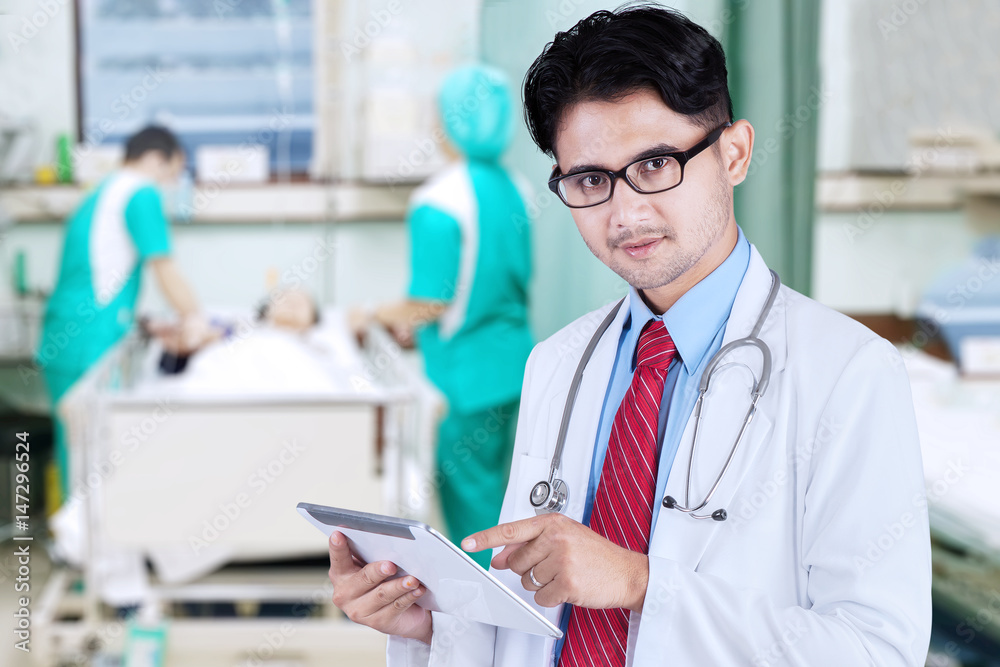 Male doctor holding digital tablet Male doctor holding digital tablet