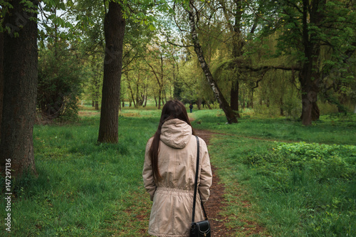 A young girl walking in the green park