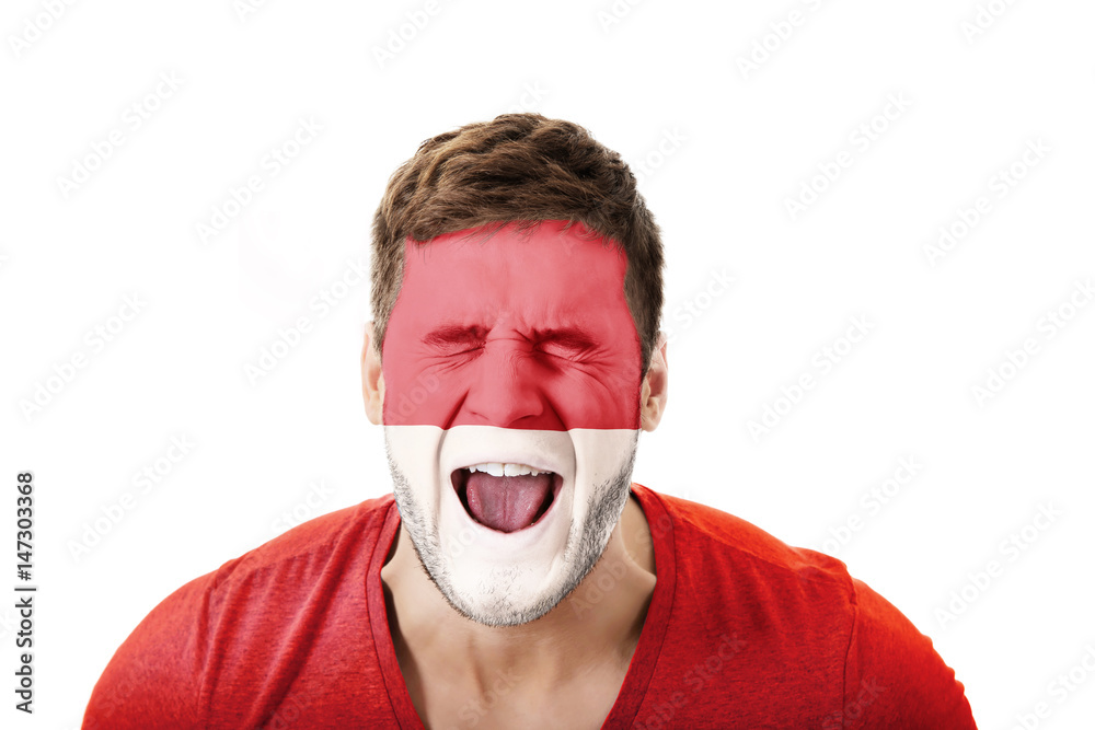 Screaming man with Monako flag on face. Screaming man with Monako flag on face.