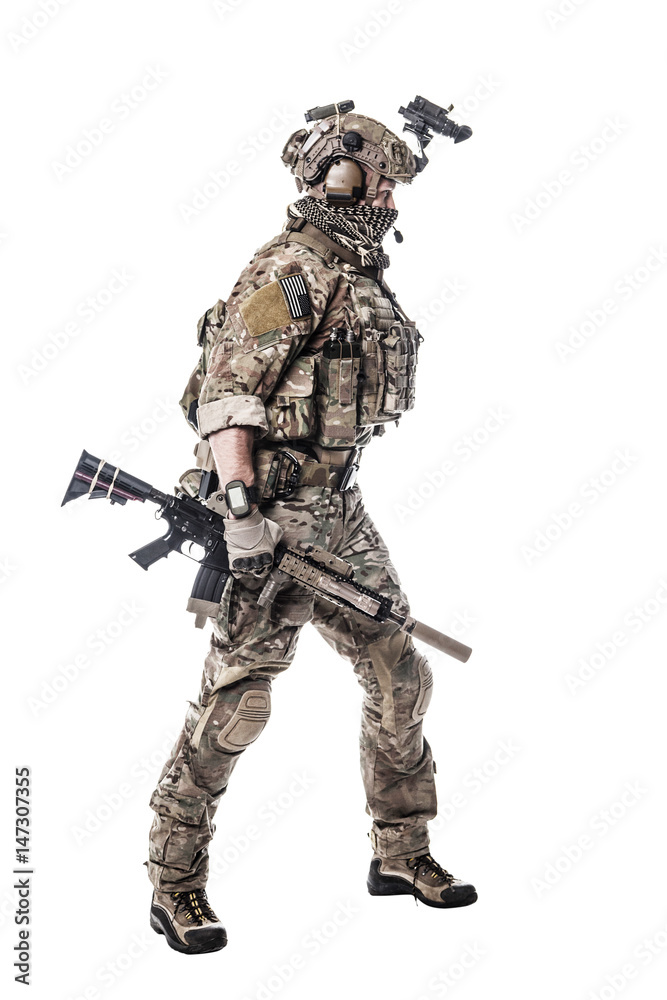 Army Ranger in field Uniforms with weapon, plate carrier and combat helmet are on, his face closed by Shemagh Kufiya scarf. Studio shot