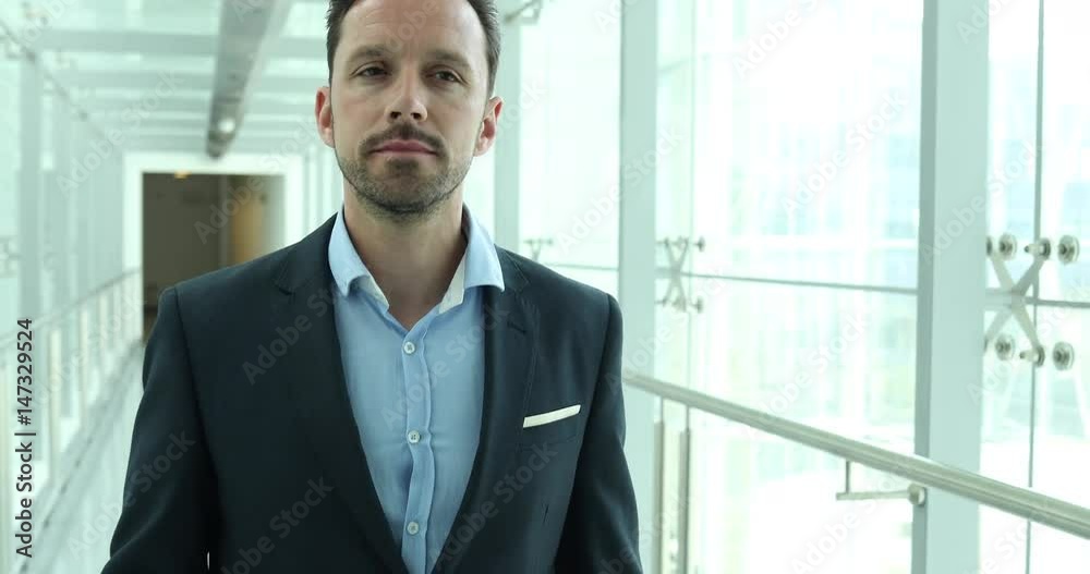 Businessman walking through airport terminal Businessman walking through airport terminal