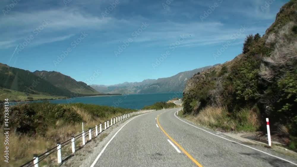 Serpentine road on ocean coast panorama view from car window in New Zealand. Scenic peaks and ridges. Beautiful background of amazing nature. Travel and tourism in the world of wildlife. Serpentine road on ocean coast panorama view from car window in New Zealand. Scenic peaks and ridges. Beautiful background of amazing nature. Travel and tourism in the world of wildlife.