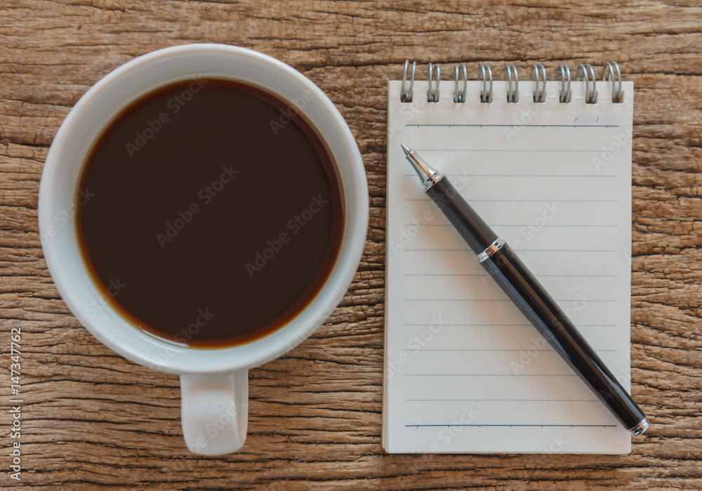 Blank notebook with pen and coffee on wooden table, business concept Blank notebook with pen and coffee on wooden table, business concept