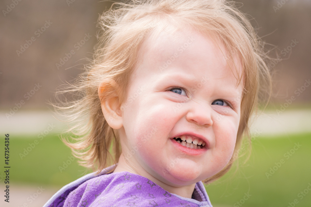 Close up of an adorable 2 year old girl playing outside Close up of an adorable 2 year old girl playing outside