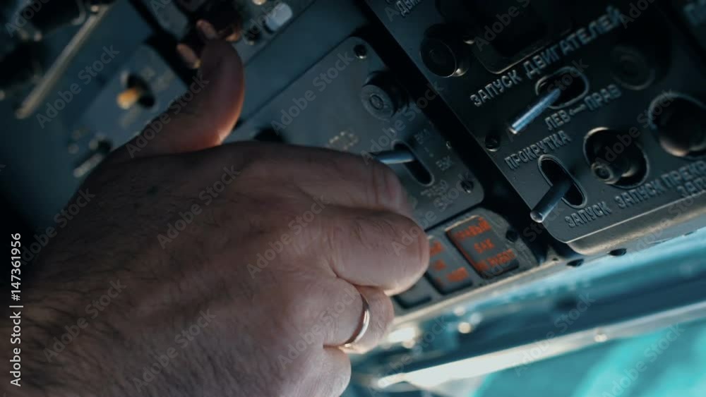 The pilot of the helicopter is preparing for the flight. The pilot of the helicopter is preparing for the flight.