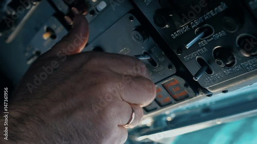 The pilot of the helicopter is preparing for the flight.