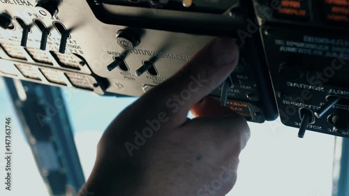 The pilot of the helicopter is preparing for the flight.