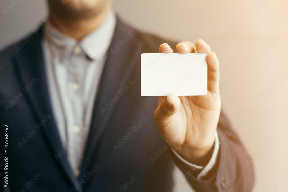 Man holding white business card,Man wearing blue shirt and showing blank white business card. Blurred background. Horizontal mockup,Businessman in office with business card in hand. Cards.