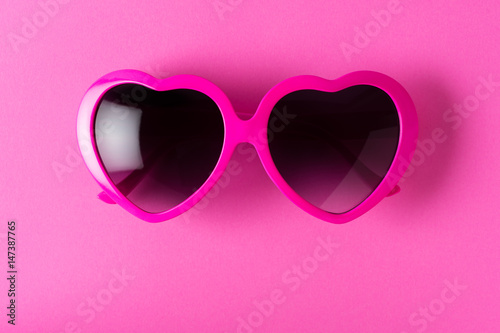 pink heart-shaped sunglasses isolated on pink background